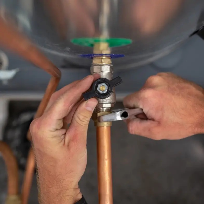 plumbing man fixing hot water cyclinder in hamilton