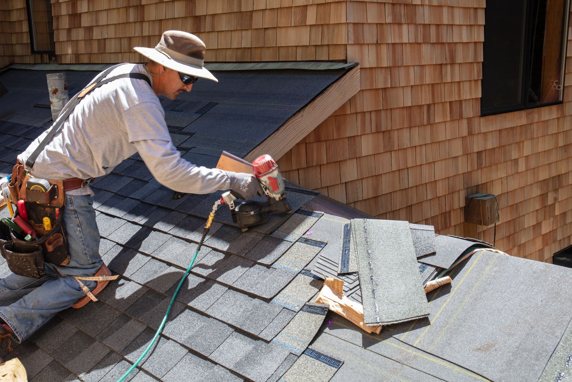 man fixing the roof in nz