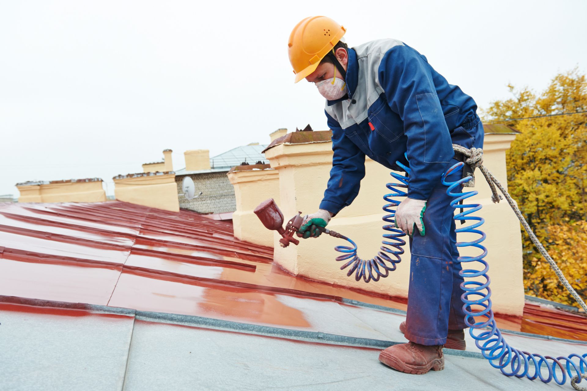 man painting the roof