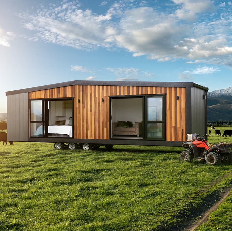 Modern New Zealand tiny home on a rural farm next to a tractor