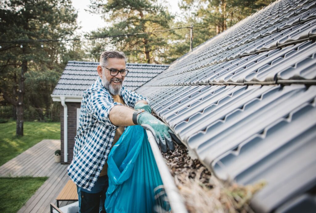 Welcome to your ultimate guide on how to clean gutters in NZ, a must-read for every homeowner looking to prevent costly water damage and maintain their property. With New Zealand’s unpredictable weather, from heavy rain to strong winds, gutters can quickly fill with leaves, dirt, and debris, leading to blockages that cause leaks, structural damage, and even pest infestations. Regular gutter cleaning is essential to protect your home, improve drainage, and extend the lifespan of your roof. Whether you’re tackling the job yourself or considering hiring a professional, this guide will walk you through why gutter maintenance matters, what tools you need, a step-by-step cleaning process, and preventative measures to keep them clear for longer. By the end, you’ll have the confidence and know-how to keep your gutters in top shape all year round. To clean gutters in NZ, start by removing large debris using gloves and a scoop. Flush the gutters with a garden hose to clear smaller particles and check for blockages in the downspout. Scrub away moss and mould using a soft brush and mild detergent. Inspect for leaks or damage and make necessary repairs. For long-term maintenance, install gutter guards, trim overhanging branches, and schedule regular cleanings twice a year, especially after autumn and spring. Why Cleaning Your Gutters Is Essential In New Zealand Gutter maintenance is one of those household tasks that’s easy to overlook—until a problem arises. In New Zealand, where the weather can be unpredictable and harsh, keeping your gutters clean is crucial for protecting your home from potential water damage, structural issues, and even pest infestations. Whether you live in a bustling city or a rural area surrounded by native bush, understanding why gutter cleaning is essential will help you prevent costly repairs and keep your home in top condition. NZ’s Weather & Gutter Maintenance Needs New Zealand’s climate presents unique challenges for homeowners when it comes to gutter maintenance. From heavy winter rainfall to strong winds and high humidity, your gutters endure a lot throughout the year. Here’s why regular cleaning is essential in NZ’s weather conditions: Heavy Rainfall in Winter New Zealand experiences significant rainfall, especially in the autumn and winter months. If gutters are blocked with leaves, dirt, or moss, they won’t be able to channel rainwater away from your home efficiently. Instead, water can overflow, leading to roof leaks, wall dampness, and foundation damage. Keeping your gutters clear ensures that water flows properly through the downspouts and away from your home, reducing the risk of moisture-related problems. High Winds Bringing Leaves & Debris Many regions in NZ, particularly coastal and hilltop areas, experience strong winds that carry leaves, twigs, and dust. Even if you don’t have trees close to your house, windblown debris can accumulate in your gutters over time. If left unchecked, this buildup forms dense clogs that block water flow, increasing the chances of overflow and water damage. Moss and Lichen Growth Due to Humidity New Zealand’s high humidity, especially in damp regions like the West Coast and Auckland, creates the perfect conditions for moss, lichen, and algae growth inside gutters. Over time, this can lead to water retention, making it easier for debris to stick and form solid blockages. Moss and lichen can also damage the protective coating of your gutters, leading to corrosion and premature wear. Cleaning your gutters regularly helps prevent this buildup and extends the lifespan of your guttering system. Consequences of Clogged Gutters Failing to maintain your gutters doesn’t just lead to minor annoyances—it can result in significant damage to your home. Here are the major risks associated with clogged gutters: Water Overflow Causing Roof Leaks When gutters become blocked, rainwater has nowhere to go. Instead of being safely directed away from your home, it overflows and seeps under roof tiles or into fascia boards. This can lead to leaks inside your home, water stains on ceilings, and even mould growth, which poses health risks to your family. Damage to Foundations and Walls A properly functioning gutter system ensures that rainwater is directed away from your home's foundation. However, clogged gutters cause water to spill over the sides, pooling around the base of your home. Over time, this erodes soil, weakens foundations, and can lead to structural cracks or sinking. If your home is built on clay soil, which expands and contracts with moisture, the risk of foundation damage is even greater. Attraction of Pests Like Rodents and Insects Still water in blocked gutters creates a perfect breeding ground for mosquitoes, flies, and other insects. Additionally, damp, debris-filled gutters attract rats, mice, and birds looking for shelter and nesting materials. Once pests settle in your gutters, it’s only a matter of time before they find a way inside your roof or walls, leading to further infestations. Regular cleaning eliminates these potential nesting spots and helps keep pests away. How Often Should You Clean Your Gutters? The frequency of gutter cleaning depends on your location and surrounding environment. However, in New Zealand, the general recommendation is to clean your gutters at least twice a year: Once in autumn, after trees have shed their leaves. Once in spring, before heavy winter rains arrive. If your home is surrounded by trees—especially pohutukawa, pine, or deciduous trees—you may need to clean your gutters every three to four months to prevent rapid buildup. Likewise, if you live in a high-wind area, checking your gutters after storms is a good practice to remove any unexpected debris. For those who struggle to keep up with regular gutter maintenance, installing gutter guards or mesh covers can help reduce debris buildup. However, even with guards, occasional cleaning is still necessary to prevent fine particles, moss, and dirt from accumulating over time. Gutter cleaning might not be the most exciting home maintenance task, but it’s one of the most important for protecting your home from water damage, structural issues, and pest problems. With New Zealand’s rain-heavy climate, strong winds, and high humidity, gutters can quickly become clogged if not maintained properly. By cleaning them at least twice a year, you’ll prevent blockages, extend the lifespan of your guttering system, and avoid costly repairs down the line. Taking a proactive approach to gutter maintenance ensures that rainwater flows where it should—away from your home, not into it. Whether you choose to clean them yourself or hire a professional, regular upkeep will save you time, money, and stress in the long run. Tools & Safety Equipment You’ll Need For Gutter Cleaning In NZ Cleaning your gutters isn’t just about scooping out leaves—it requires the right tools and a strong focus on safety to prevent accidents. Many homeowners underestimate the risks involved, but falling from a ladder or dealing with sharp debris can cause serious injuries. Before you get started, it’s important to gather essential cleaning tools and take proper safety precautions to ensure a smooth and hazard-free gutter cleaning session. Essential Cleaning Tools Having the right tools makes gutter cleaning easier, faster, and safer. Below are the must-have items for an effective gutter maintenance routine. Sturdy Ladder (with Stabilizers) A high-quality, stable ladder is crucial for reaching your gutters safely. A telescopic or extension ladder works best for multi-story homes, while a step ladder may be sufficient for single-story properties. Look for ladders with non-slip feet and stabilizing arms to prevent wobbling. If possible, use a ladder stabilizer or stand-off to rest the ladder securely against the roof rather than the fragile gutter itself. Pro Tip: Always place the ladder on firm, level ground, and avoid leaning too far to the sides—this is one of the leading causes of ladder-related injuries. Heavy-Duty Gloves Gutter debris often contains sharp twigs, nails, roofing material, and decomposed leaves, which can be dirty and hazardous. A pair of thick, waterproof gloves will protect your hands from cuts, bacteria, and pests like spiders or rodents that may be hiding in the debris. Rubber-coated gloves offer excellent grip and durability. Gutter Scoop or Small Trowel A gutter scoop or hand trowel helps remove compact debris, sludge, and leaves with ease. Some scoops are specially designed to fit standard gutter widths, making them more efficient than using your hands alone. If you don’t have a gutter scoop, an old plastic kitchen spatula can also do the trick. Alternative Option: If you prefer a hands-free approach, consider using a gutter cleaning vacuum attachment or a telescopic pole with a scoop attachment to reach gutters without climbing a ladder. Bucket or Garbage Bag for Debris Collection Instead of throwing debris onto the ground, use a sturdy bucket or garbage bag to collect leaves and dirt. A bucket with a handle hook that can attach to the ladder will free up your hands, making the job more manageable. If composting is an option, organic gutter waste can be reused for your garden. Garden Hose or Pressure Washer Once the bulk of the debris is removed, flushing the gutters with a garden hose or pressure washer will help clear out fine particles, dirt, and small obstructions. A hose with an adjustable nozzle is ideal for controlling water pressure, while a pressure washer can be used on a low setting to remove stubborn grime and moss buildup. Pro Tip: Start rinsing from the farthest end of the gutter, pushing debris toward the downspout. If water pools instead of flowing freely, there may be a clog that needs to be cleared. Gutter Brush or Soft-Bristle Scrubbing Brush For gutters covered in moss, mould, or algae, a soft-bristle brush or a gutter-cleaning brush can help scrub away buildup. Using a mild cleaning solution—such as vinegar and water—instead of harsh chemicals can be more eco-friendly and won’t damage your gutters. Safety First: Gutter Cleaning Safety Tips Cleaning gutters involves working at heights, handling debris, and using water, so safety should always come first. Taking a few precautions can significantly reduce the risk of falls and injuries. Ladder Safety Tips Place the ladder on solid, level ground to prevent tipping. Avoid soft or uneven surfaces. Use a ladder stabilizer to keep the ladder secure and prevent it from damaging the gutters. Never overreach! Keep your body between the ladder rails and move the ladder as needed. Have a helper nearby to hold the ladder and assist if needed. Don’t climb too high—your waist should not be above the top rung of the ladder. Pro Tip: If your gutters are too high to reach safely, consider using an extendable gutter cleaning tool or hiring a professional gutter cleaning service instead. Wear Protective Gear Gloves: Protect your hands from cuts, bacteria, and insects. Eye protection: Wear safety goggles to shield your eyes from debris and dirty water splashes. Non-slip shoes: Avoid sandals or slippery footwear—use rubber-soled shoes for better grip. Long-sleeved clothing: Protect your arms from scratches and insect bites. Be Mindful of the Weather Never clean gutters in bad weather. Rain makes ladders and roofs slippery, increasing fall risks. Avoid windy conditions. Strong gusts can cause instability while on a ladder. Choose a dry, cool day. The best time to clean gutters is on a mild, dry day to avoid overheating or dealing with wet, heavy debris. Having the right tools and safety measures in place is key to a successful and risk-free gutter cleaning experience. By investing in quality equipment and following basic safety practices, you can maintain your gutters efficiently while protecting yourself from accidents. If you’re unsure about ladder work or dealing with severe clogs, it’s always best to call a professional gutter cleaning service to handle the job safely. Taking a preventative approach to gutter maintenance ensures that your home remains protected from water damage all year round. Keep these tools handy, follow safety protocols, and enjoy clog-free gutters that keep your home in top shape! Step-By-Step Guide To Cleaning Gutters In NZ Keeping your gutters clean is essential for preventing water damage, improving drainage, and maintaining the overall health of your home. With New Zealand’s unpredictable weather, leaves, dirt, and moss can accumulate quickly, leading to clogged gutters that overflow or even cause structural issues. Below is a detailed, step-by-step guide to ensure you clean your gutters safely and effectively. Step 1: Inspect Your Gutters Before you start cleaning, it’s crucial to assess the current state of your gutters. This helps you understand the level of debris buildup and spot any potential damage. Check for visible blockages and standing water – If you notice water pooling in sections of the gutter, it may indicate a clog or improper drainage. Look for signs of damage – Inspect for rust, cracks, sagging sections, or loose brackets. Over time, debris buildup and water weight can weaken the structure of your gutters, leading to potential leaks or detachment from the roof. Assess the downspouts – Ensure water is flowing freely and there are no visible blockages at the base. If your gutters are severely damaged or sagging, you may need repairs before cleaning. Ignoring structural issues can result in costly damage down the line. Step 2: Remove Large Debris by Hand Once you’ve inspected your gutters, the next step is to manually remove large debris such as leaves, twigs, and dirt. These materials can quickly clog your gutter system, preventing proper water flow. Wear protective gloves – Gutters often contain sharp objects, wet leaves, and even insects, so wearing thick, waterproof gloves is essential. Use a gutter scoop or small trowel – This makes it easier to collect leaves and sludge without making a mess. Dispose of debris properly – If the materials are organic, consider adding them to your compost bin or garden waste rather than sending them to landfill. By removing the bulk of the debris first, you make the next steps of the cleaning process much easier and more effective. Step 3: Flush Gutters with a Hose After removing large debris, it’s time to flush out smaller dirt particles using a garden hose. This step ensures that no residual buildup is left behind, keeping the gutters clear for proper drainage. Start from the end farthest from the downspout – This helps push any remaining debris toward the exit point rather than causing further blockages. Use a hose with a spray attachment – A high-pressure setting can help dislodge any stubborn dirt stuck to the gutter walls. Watch for water pooling – If water fails to drain properly, there may be a clog in the downspout that needs attention. This step not only cleans your gutters but also helps identify drainage issues that could lead to future problems if left unaddressed. Step 4: Check & Clear Downspouts Your downspouts are responsible for directing rainwater away from your home’s foundation, so they must remain unclogged and fully functional. If you notice water backing up instead of flowing freely, follow these steps to clear the blockage: Flush the downspout with a hose – Insert the hose at the top and run water through it to see if the flow is smooth. Use a plumber’s snake or drain auger – If water isn’t flowing, feed a plumbing snake through the downspout to break up the clog. Try tapping the downspout – Sometimes, gently tapping the sides of the pipe can help dislodge compacted debris. For downspouts that remain clogged despite these efforts, consider detaching and cleaning them separately before reattaching them to the gutter system. Step 5: Scrub Away Moss & Mould New Zealand’s damp climate makes gutters a prime location for moss, algae, and mould growth. Over time, this buildup can not only clog your gutters but also contribute to corrosion and damage. To effectively clean them: Use a soft-bristle brush and mild detergent – Scrub the inside of the gutters gently to remove any lingering dirt or moss. Try eco-friendly cleaning solutions – A mix of vinegar and water or baking soda and water can break down mould naturally without harming the environment. Rinse thoroughly with a hose – Ensure no residue remains after scrubbing. This step is particularly important in shaded or damp areas where moss tends to grow more aggressively. Step 6: Inspect & Repair Any Issues Now that your gutters are clean, do a final inspection to ensure everything is in good condition and functioning properly. Look for loose brackets and sagging gutters – Tighten any screws or supports that may have loosened over time. Check for leaks – Small holes or cracks can be sealed with waterproof gutter sealant. Consider replacing rusted or damaged sections – If you notice severe corrosion, it may be time to replace a section of your gutters before it causes further issues. Regular inspections and minor repairs help extend the lifespan of your gutter system and prevent more expensive problems down the line. Cleaning your gutters may not be the most exciting home maintenance task, but it’s an essential one that helps prevent costly water damage, improve drainage, and protect your home’s structure. By following this step-by-step guide, you’ll ensure that your gutters remain in top condition throughout the year. For long-term maintenance, consider installing gutter guards, trimming overhanging branches, and scheduling regular checks, especially after storms. If your gutters are difficult to reach or severely clogged, don’t hesitate to call a professional gutter cleaning service for assistance. Keeping your gutters clean is a simple yet powerful way to safeguard your home—so don’t wait until problems arise. Take action today and enjoy a well-maintained, worry-free gutter system! Preventative Maintenance: Keeping Your Gutters Clean Longer Cleaning your gutters is important, but keeping them clean for longer is even better. Preventative maintenance not only reduces the frequency of manual cleaning but also helps extend the life of your gutters and prevents costly home repairs. Below are four key strategies to keep your gutters clear, functional, and efficient year-round in New Zealand’s changing weather conditions. Install Gutter Guards: The First Line of Defense Gutter guards are one of the best investments for minimizing debris buildup and reducing the need for frequent cleaning. These protective barriers come in different forms, including mesh screens, foam inserts, and brush-style guards, all designed to keep out leaves, twigs, and other debris while allowing rainwater to flow through. Benefits of Gutter Guards: Prevents Clogs: Stops leaves and debris from accumulating in the gutter system. Reduces Cleaning Frequency: While gutters still need occasional maintenance, guards can cut down cleaning time by 50% or more. Extends Gutter Lifespan: Prevents water buildup and rust caused by trapped moisture. Deters Pests: Stops birds, rodents, and insects from nesting in your gutters. Choosing the Right Gutter Guard for Your Home: Mesh Screens – Ideal for keeping out small debris and pests, but requires occasional brushing to remove fine particles. Foam Inserts – Easy to install and blocks large debris, but may need periodic replacement. Brush Gutter Guards – Allows water to flow through easily, but works best in low-debris areas. For New Zealand homes, mesh screens tend to be the most effective option as they balance durability and maintenance needs, making them suitable for homes in areas with frequent rain and strong winds. Trim Overhanging Branches: Reduce Leaf Buildup One of the biggest contributors to gutter blockages is falling leaves and twigs from nearby trees. If you have trees overhanging your roof, trimming them back can drastically reduce the amount of debris that ends up in your gutters. How Tree Branches Affect Your Gutters: Increased Leaf Accumulation: More leaves in your gutters mean more frequent clogs. Gutter Damage: Branches that scrape against the roof and gutters cause wear and tear over time. Pest Problems: Overhanging branches provide easy access for birds, rodents, and insects to nest in your gutters. How to Trim Trees for Better Gutter Protection: Cut branches so they are at least 2-3 meters away from your roof. Regularly prune fast-growing trees such as willows and poplars. Hire an arborist for tall trees to avoid damaging the tree or your home. By trimming trees seasonally, you prevent excessive leaf buildup while keeping your roof and gutters in better condition year-round. Regular Checks After Storms: Clear Debris Quickly New Zealand’s stormy weather can wreak havoc on your gutters, bringing down leaves, dirt, and even small branches that quickly lead to blockages. After heavy rain, strong winds, or a storm, it’s crucial to inspect and clear your gutters as soon as possible to prevent water damage, leaks, and structural issues. Why Post-Storm Gutter Checks Are Essential: Prevents Water Overflow: Clogged gutters after a storm trap rainwater, leading to roof leaks and foundation damage. Reduces Long-Term Damage: Leaves and debris left sitting in gutters can cause mould, rust, and sagging. Identifies Gutter Damage Early: Storms can loosen brackets or create cracks, so checking early prevents bigger repairs later. How to Inspect Your Gutters After a Storm: Walk around your property and look for overflowing or sagging gutters. Check downspouts to ensure water is flowing freely and isn’t clogged. Use a ladder to remove larger debris like twigs or trapped leaves. Flush gutters with water to remove any small particles and test the drainage system. Even a quick 10-minute inspection after a storm can save you thousands in repairs and keep your gutters functioning properly. Ensure Proper Downspout Drainage: Direct Water Away from Your Home Even if your gutters are clean and clear, poor downspout drainage can lead to serious water damage around your home. If rainwater isn’t properly directed away, it can pool around your foundation, weaken structures, and even flood basements or crawl spaces. How to Improve Downspout Drainage: Extend Downspouts: Attach a downspout extender or drainage pipe to direct water at least 1.5–2 meters away from your home. Use Splash Blocks: Place splash blocks at the base of downspouts to prevent soil erosion. Check for Clogs: If water isn’t flowing freely, remove blockages using a hose or plumber’s snake. Angle Downspouts Correctly: Ensure your downspouts slope downward to prevent pooling. If your property is prone to heavy rainfall and flooding, consider installing a rainwater collection system to redirect excess water for gardening or drain it safely into a stormwater system. By following these preventative maintenance tips, you can significantly reduce gutter blockages, prevent costly repairs, and extend the lifespan of your gutters. Installing gutter guards, trimming trees, inspecting after storms, and ensuring proper drainage all contribute to a more efficient, low-maintenance system that protects your home year-round. Taking small, proactive steps today will save you time, effort, and money in the long run—keeping your home safe from leaks, structural damage, and unexpected repair costs. When To Call A Professional For Gutter Cleaning In NZ While DIY gutter cleaning can be a cost-effective way to maintain your home, there are times when calling in a professional is the safest and most practical choice. Whether it's due to safety concerns, severe blockages, lack of time, or the need for specialized tools, hiring an expert ensures the job is done efficiently and correctly. Below, we’ll break down the key reasons to consider professional gutter cleaning services in New Zealand, along with a general cost overview. When Gutters Are Too High to Safely Reach One of the biggest risks of cleaning gutters yourself is working at height, especially if your home has multiple stories. Standard household ladders often aren’t tall enough to reach second-story gutters safely, increasing the risk of falls and injuries. Even for single-story homes, balancing on a ladder while scooping out debris can be hazardous, particularly for those who aren’t used to working at heights. Professional gutter cleaners come equipped with specialized ladders, safety harnesses, and stabilizing equipment to handle high or hard-to-reach gutters safely. They are trained to navigate steep roofs and tricky angles, reducing the chances of accidents. If you feel uneasy about climbing a ladder or don’t have the right equipment, hiring a professional is the best way to ensure your safety. If There Are Severe Blockages or Damage Gutters that haven’t been cleaned for an extended period can develop severe blockages due to built-up leaves, dirt, moss, and even bird nests. These clogs prevent water from flowing properly, leading to overflowing gutters, roof leaks, and potential water damage to your home’s foundation. In some cases, downspouts may become completely blocked, requiring more than just a simple rinse with a hose to clear them. A professional gutter cleaning service has the right tools and expertise to handle stubborn clogs efficiently. They use high-powered vacuums, pressure washers, and drain snakes to clear out even the toughest blockages. Additionally, they can inspect your gutters for hidden damage, such as cracks, rust, or loose fasteners, and recommend necessary repairs before small issues turn into expensive problems. If You Lack the Necessary Tools or Time Cleaning gutters isn’t just about scooping out leaves—it requires a range of tools to do the job thoroughly. Basic equipment includes sturdy ladders, gutter scoops, heavy-duty gloves, garden hoses, and gutter brushes. If you need to flush out downspouts, you may require a plumber’s snake or pressure washer. Many homeowners don’t have these tools readily available, and purchasing them for occasional use can be costly. Beyond the equipment, gutter cleaning is a time-consuming task, especially if your gutters haven’t been maintained regularly. A professional service can complete the job in a fraction of the time it might take you, ensuring a thorough clean without disrupting your busy schedule. For those who have large properties or multiple rental properties, hiring a professional can be a practical, time-saving solution. How Much Does Professional Gutter Cleaning Cost in NZ? The cost of hiring a professional gutter cleaner in New Zealand varies based on several factors, including the size of your home, the height of your gutters, the level of debris buildup, and whether any repairs are needed. Here’s a general pricing breakdown: Single-story homes: $100 – $250 Two-story homes: $250 – $400 Large or multi-story homes: $400 – $600 Severely clogged gutters or additional repairs: Extra costs may apply Some companies offer package deals that include roof inspections, minor repairs, or moss and lichen removal, which can be beneficial for homeowners looking for comprehensive roof maintenance. If you have gutter guards installed, you may also be charged an additional fee for removal and reinstallation. When It’s Worth Hiring a Professional While many homeowners can handle basic gutter cleaning themselves, certain situations call for expert help. If your gutters are high, severely blocked, or in need of repairs, or if you simply lack the time and equipment, hiring a professional is a smart investment in your home’s maintenance. By ensuring your gutters remain clear and functional, you can prevent costly water damage, extend the lifespan of your roofing system, and maintain your property’s value. If you’re unsure whether to tackle the job yourself or call in a professional, consider getting a free quote from a local gutter cleaning service. Many companies provide affordable and hassle-free solutions, giving you peace of mind and saving you time in the long run.