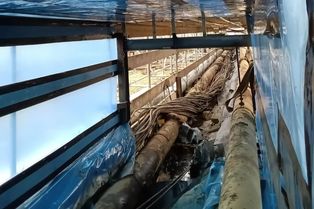 Asbestos Testing and Removal containment setup around industrial pipes in New Zealand.