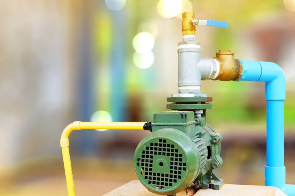 Small green outdoor water pump setup installed by professional water pump installers in New Zealand.