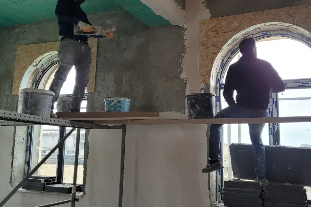 Interior rendering work in progress by plasterers in a New Zealand building.