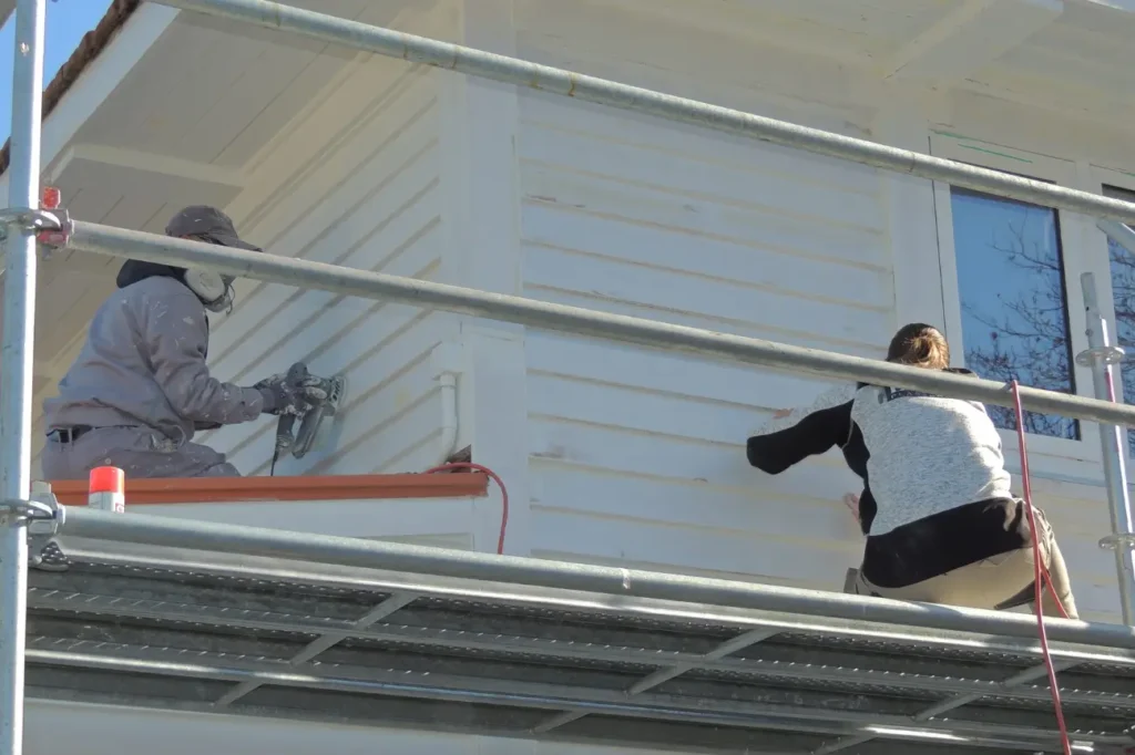 Surface preparation on a weatherboard home in New Zealand by professional contractors.