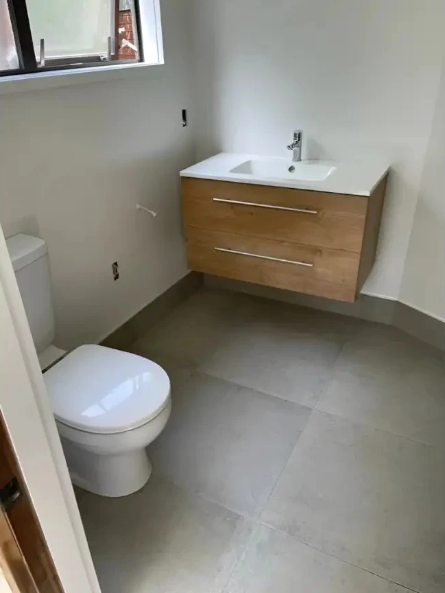 Modern bathroom with floating vanity and toilet showcasing bathroom renovations in New Zealand.