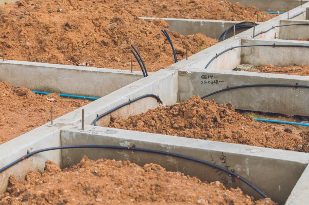 Concrete strip footings with plumbing and service conduits installed during early foundation construction by Foundation Contractors New Zealand.