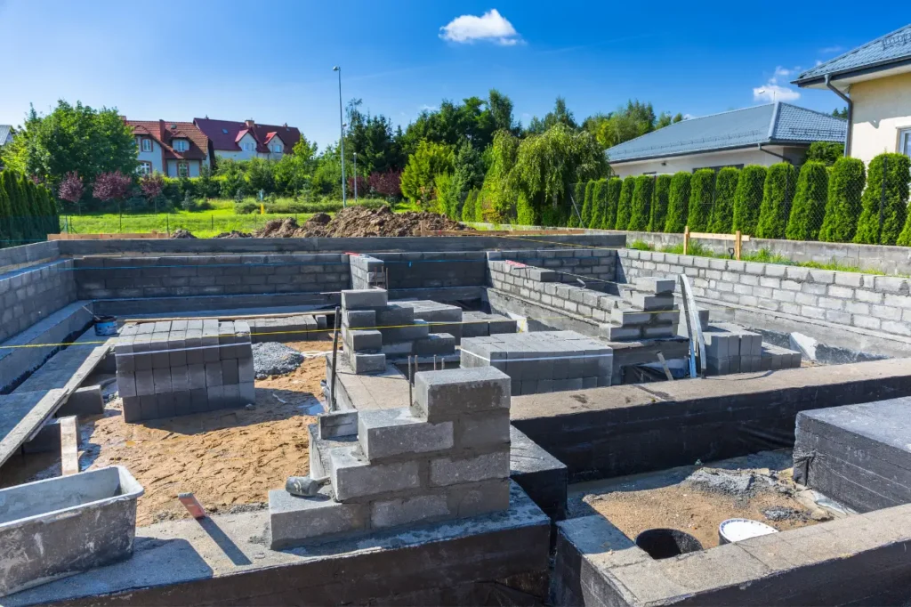Residential house foundation under construction with concrete blocks and groundwork in progress by professional Foundation Contractors New Zealand