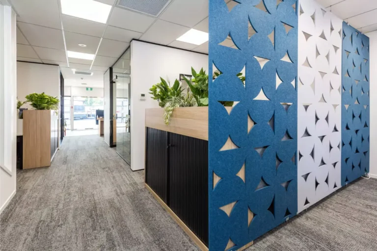 Modern office corridor featuring decorative acoustic wall panels, indoor plants, and glass partitions in an Office Fit Outs New Zealand project.