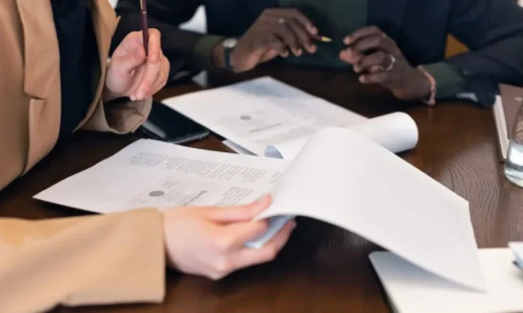 Quantity Surveyor in New Zealand reviewing labour only cost estimates and construction documentation during a professional consultation.