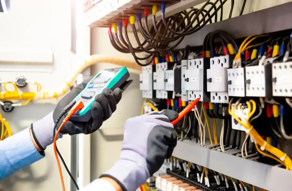 Licensed electricians performing Switchboard Upgrades using testing equipment in New Zealand.