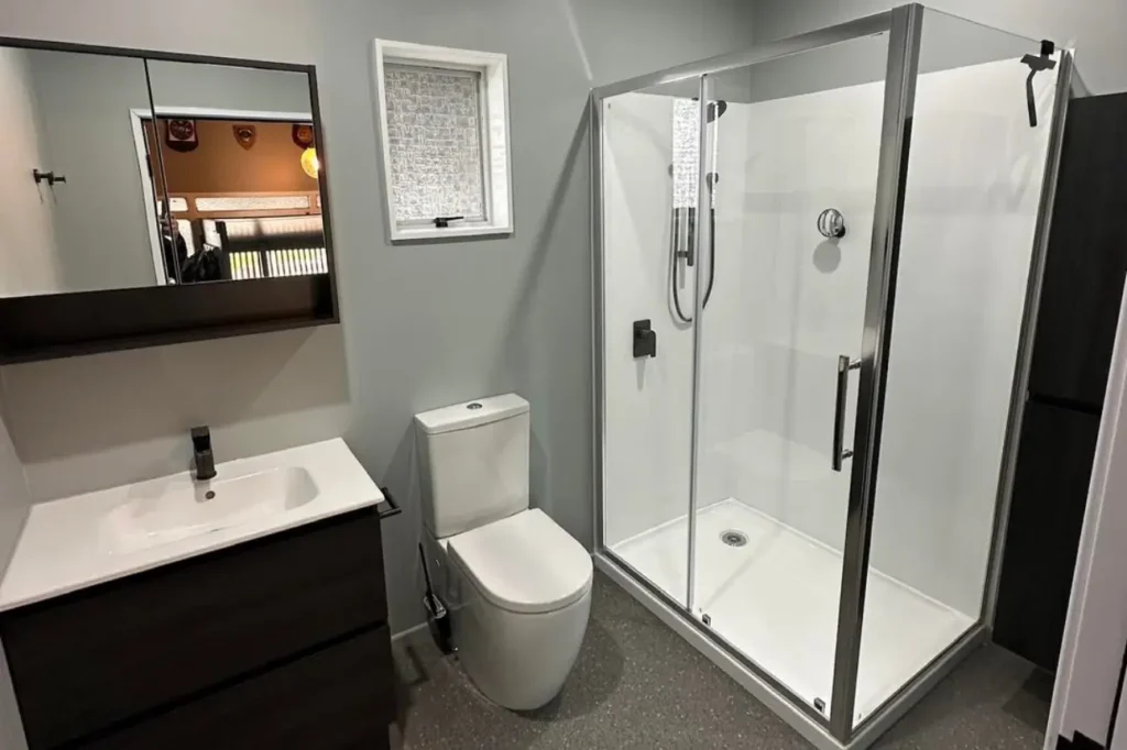 Professionally managed Bathroom Renovations in New Zealand featuring a modern shower enclosure sleek vanity and efficient layout.