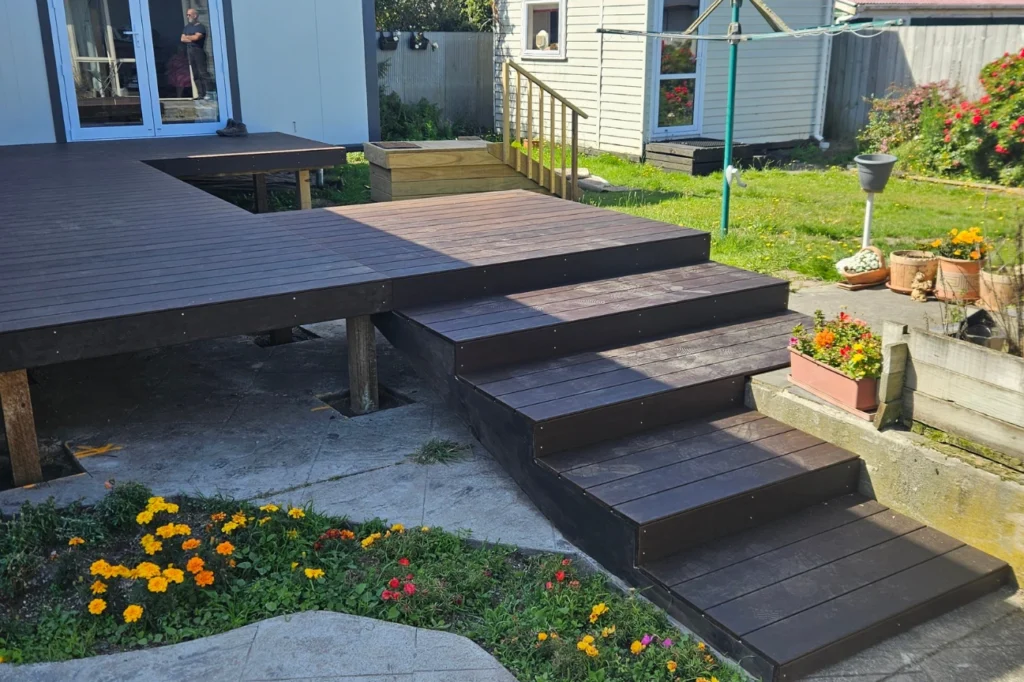 Multi level dark timber deck with steps built by deck builders New Zealand.