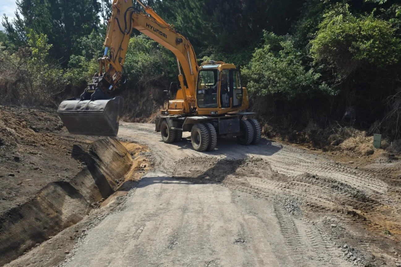 Heavy excavator performing earthworks and road preparation in New Zealand.