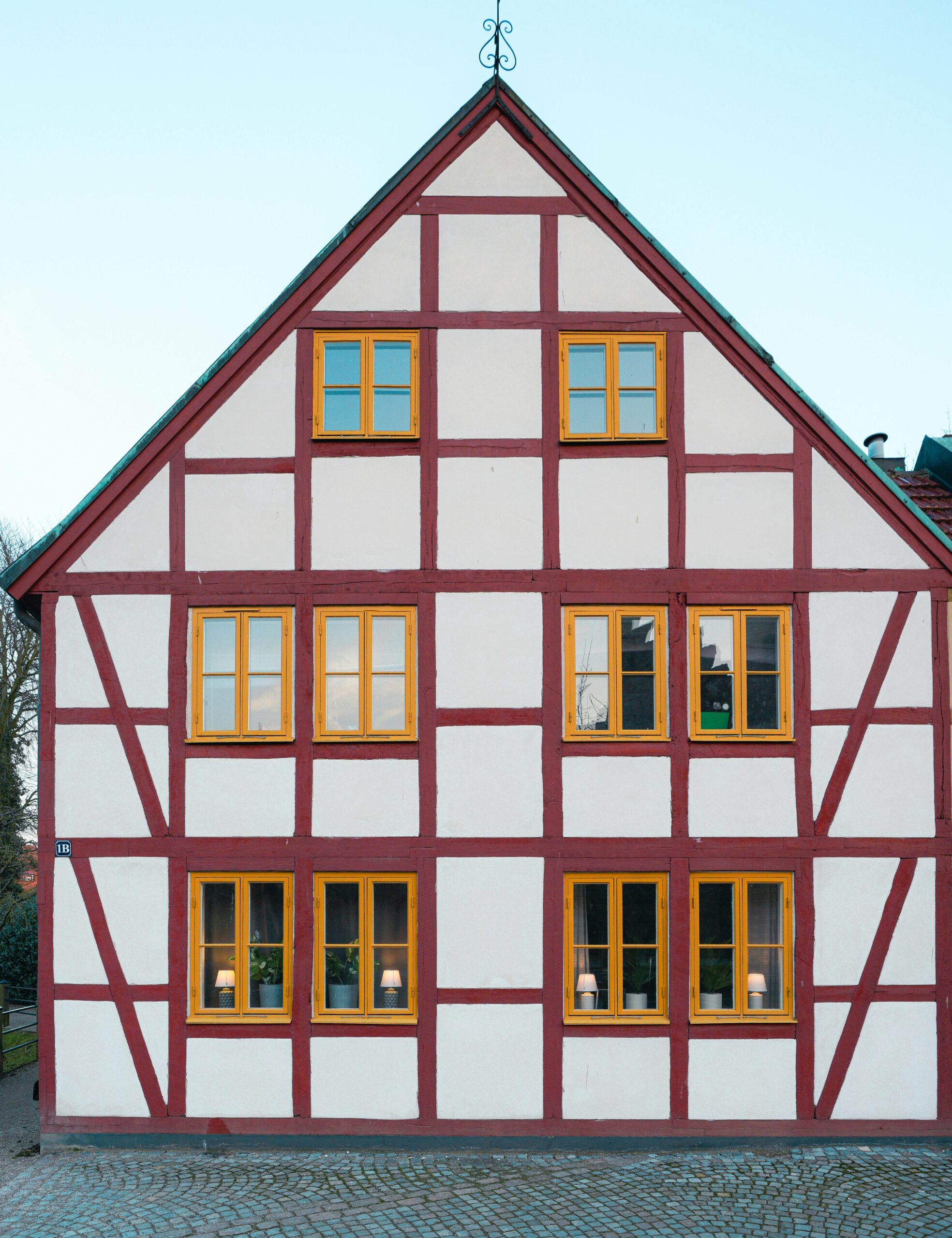 Beautifully preserved half-timbered house with yellow windows in Ystad, Sweden.